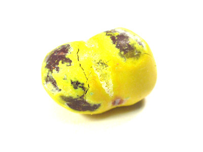 A yellow double-nut with patchy shell, as though the insides can't be contained.