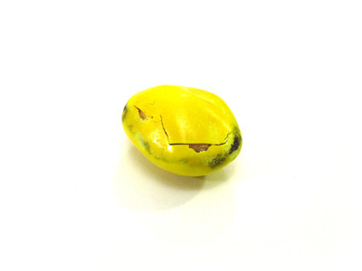 Yellow nut, with vague dark bruising and a zigzag crack from left to right.