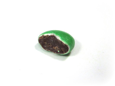 A plain green, pretty much cleaved in half, showing chocolate, white shell, and green outer dye.