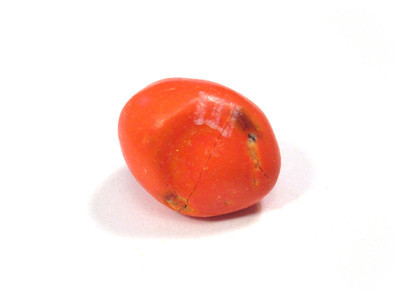 Orange, with what seems to be a half-nut inside, perturbing the surface to make a smoothed crater. Also a straight hairline crack right across the middle.