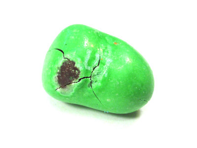 A big green double nut, with some thin but prominent cracks, and a dark rubbed-off spot on the left side.