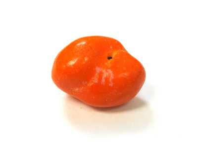 Orange double-nut, with a small hole in the shell, where they meet.